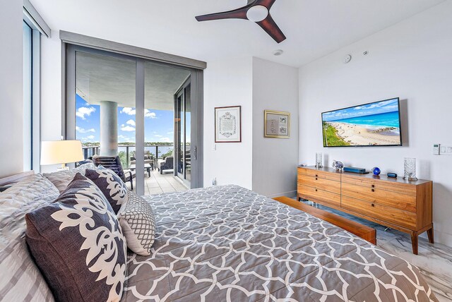 bedroom featuring access to exterior, ceiling fan, and a wall of windows