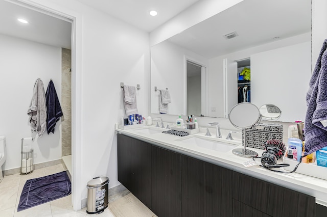 bathroom with a shower, tile patterned flooring, toilet, and vanity