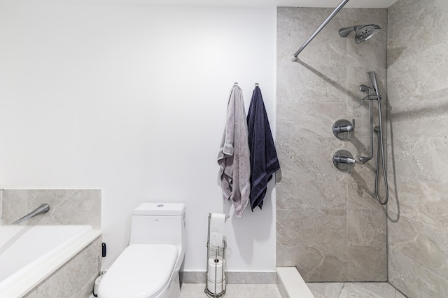 bathroom with toilet and a tile shower