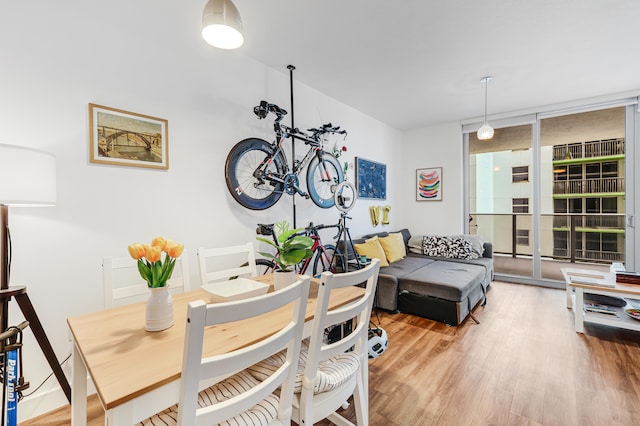 dining area featuring light hardwood / wood-style flooring and floor to ceiling windows