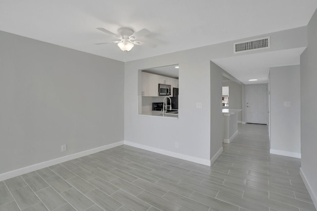 unfurnished living room featuring ceiling fan