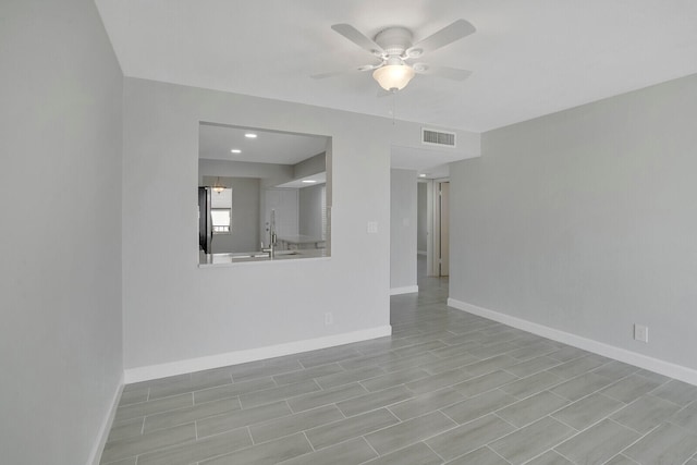 empty room featuring sink and ceiling fan