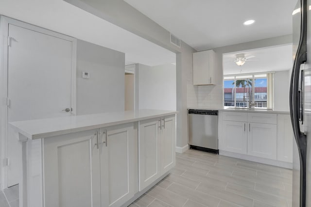 kitchen featuring white cabinets, light tile patterned floors, dishwasher, ceiling fan, and black fridge