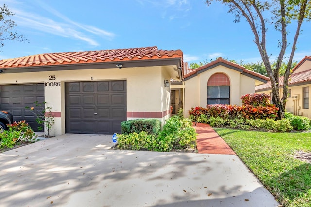 mediterranean / spanish-style home with a garage