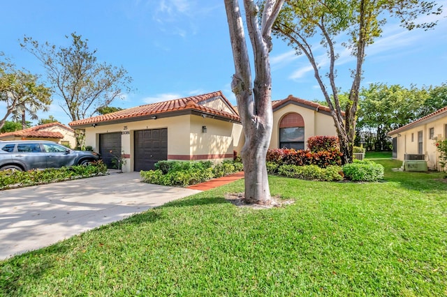 mediterranean / spanish-style house featuring a garage, a front yard, and central air condition unit