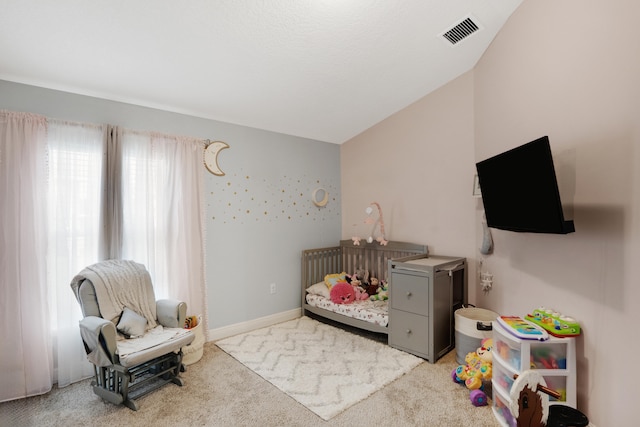 bedroom with lofted ceiling and light colored carpet