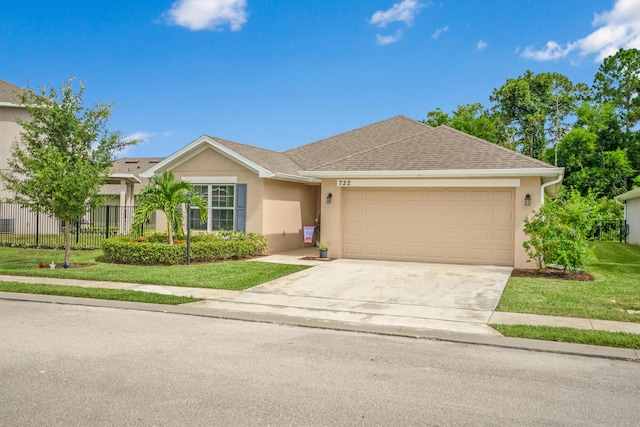 single story home with a front yard and a garage