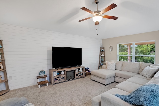 carpeted living room with ceiling fan