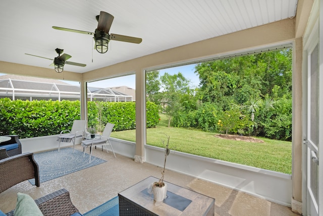 sunroom featuring ceiling fan