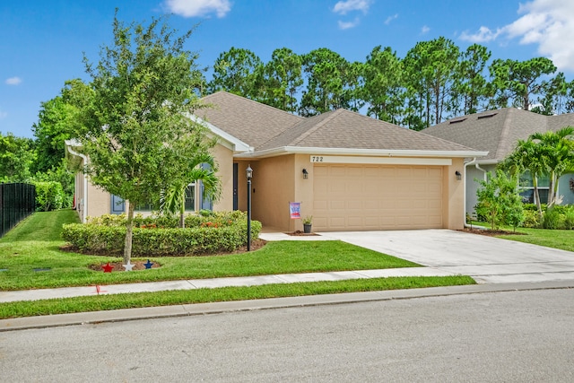 view of front of property featuring a front yard and a garage