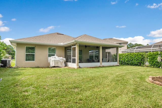 back of house featuring a yard, a sunroom, and central AC unit