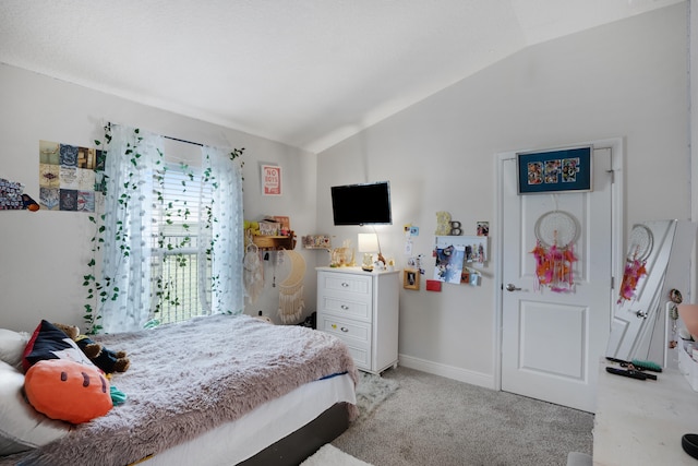 bedroom featuring light carpet and vaulted ceiling