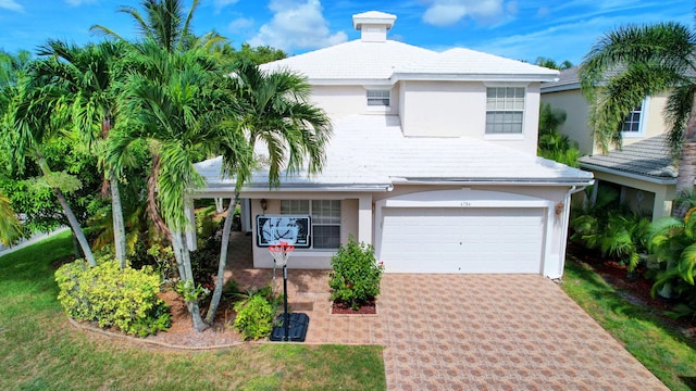 view of front of property featuring driveway, stucco siding, and a garage