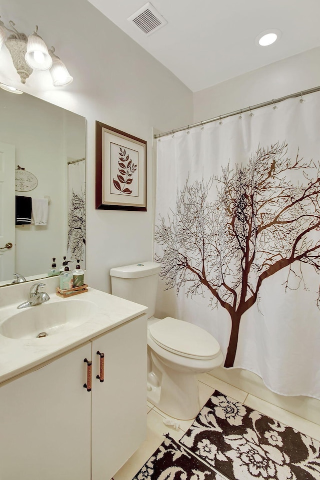 bathroom with vanity, tile patterned flooring, and toilet