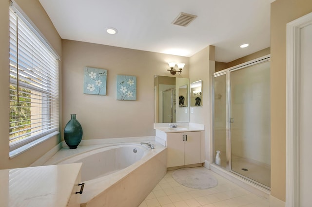 bathroom featuring tile patterned flooring, plus walk in shower, and vanity