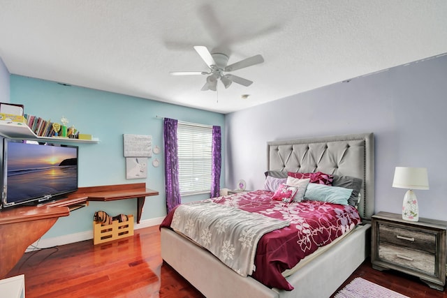 bedroom with baseboards, a ceiling fan, and wood finished floors