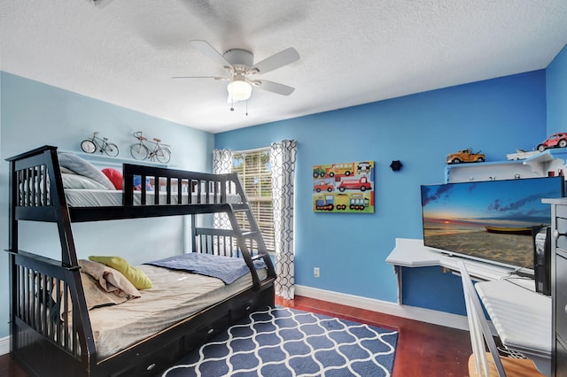 bedroom with a textured ceiling, wood finished floors, ceiling fan, and baseboards