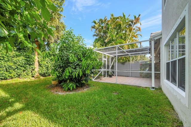 view of yard with a lanai and a patio