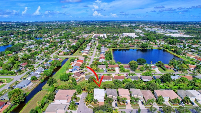 birds eye view of property featuring a water view and a residential view