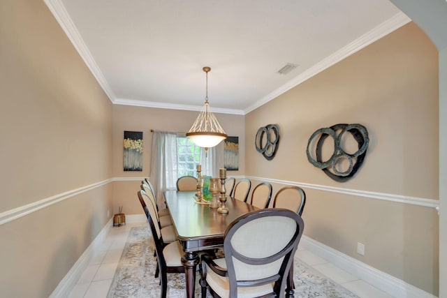 dining room with visible vents, baseboards, arched walkways, crown molding, and light tile patterned flooring