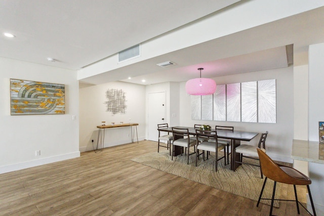 dining area featuring recessed lighting, visible vents, and wood finished floors