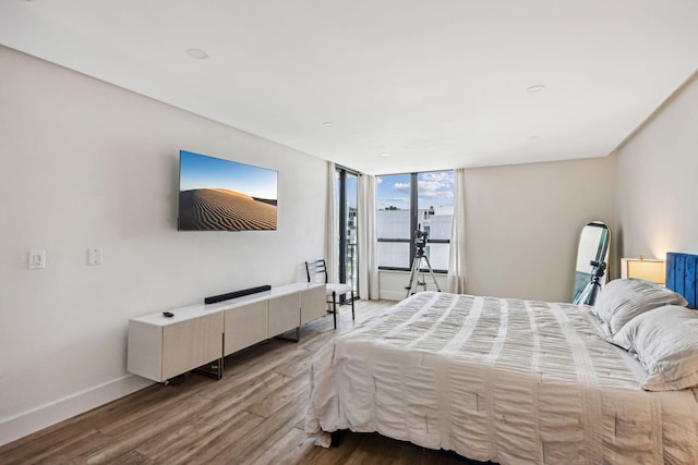 bedroom featuring baseboards and wood finished floors