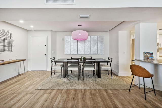 dining space with baseboards, recessed lighting, visible vents, and wood finished floors