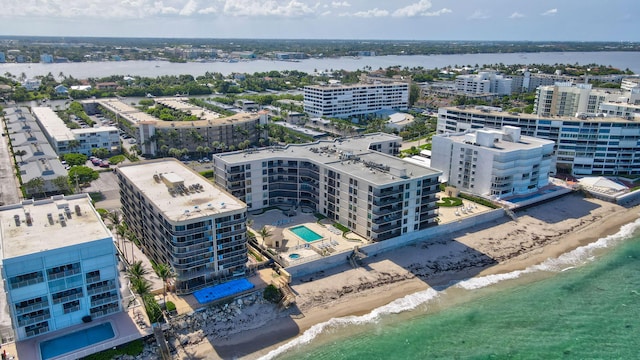 aerial view with a city view, a water view, and a view of the beach