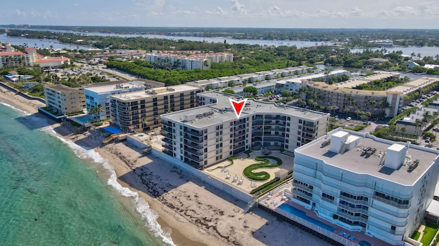 drone / aerial view featuring a water view and a view of the beach