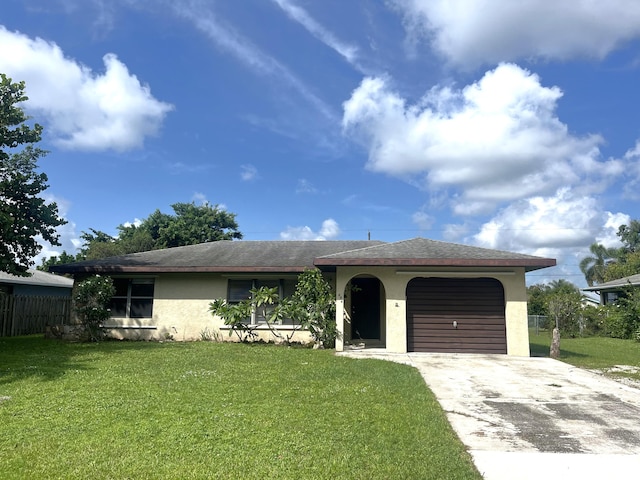 single story home with a garage and a front yard