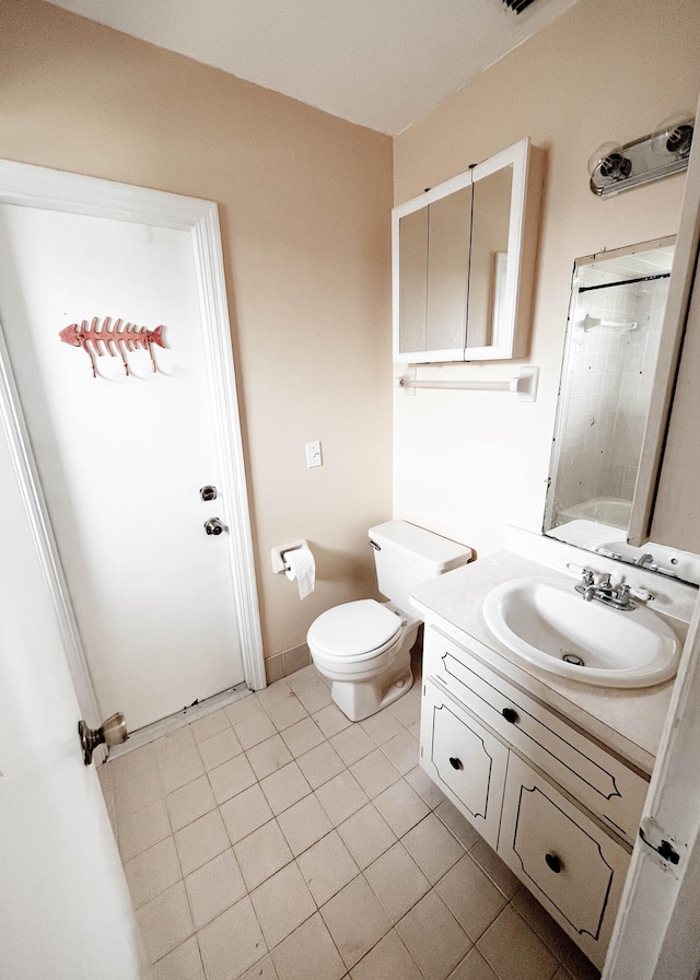 full bathroom featuring vanity, toilet, tiled shower / bath, and tile patterned flooring