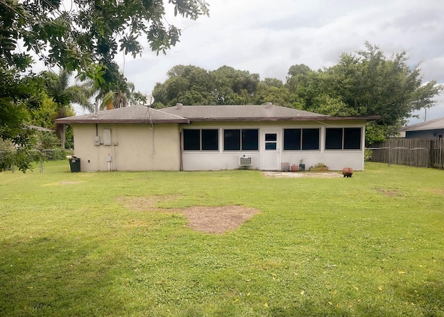 back of house featuring a lawn