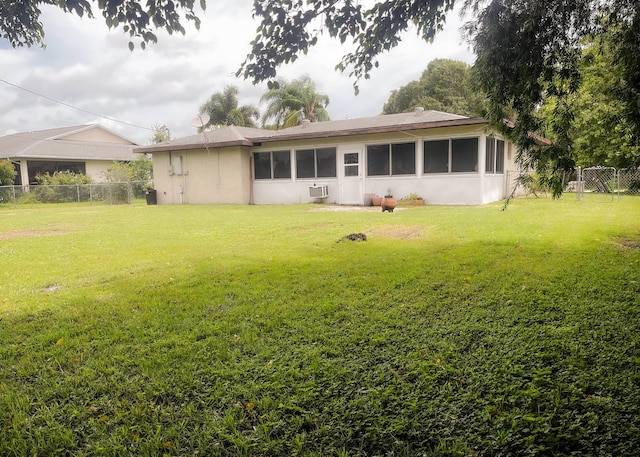 back of house featuring a yard