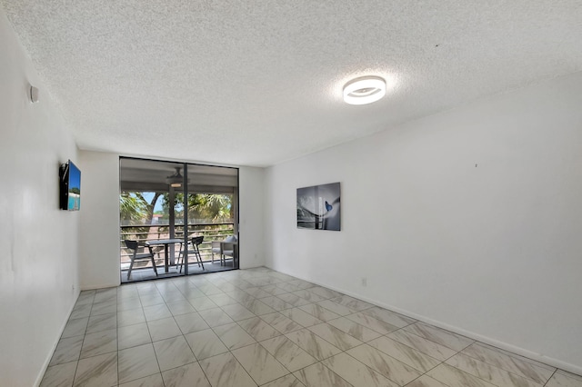 unfurnished room with a textured ceiling