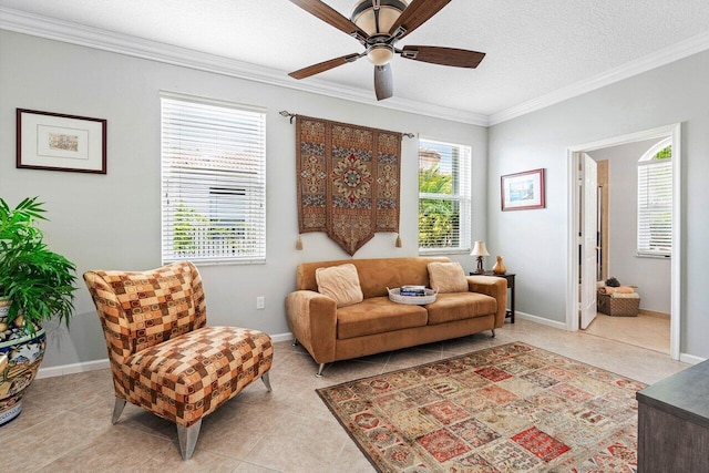 sitting room with light tile patterned flooring, ceiling fan, a textured ceiling, and ornamental molding