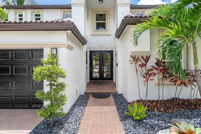 view of front of house with a garage and french doors