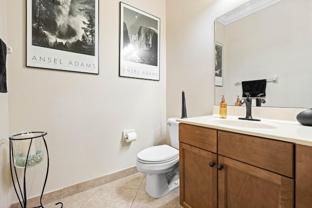 bathroom with toilet, vanity, tile patterned flooring, and ornamental molding