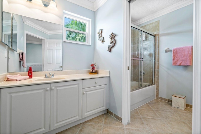 bathroom with combined bath / shower with glass door, vanity, tile patterned floors, and crown molding