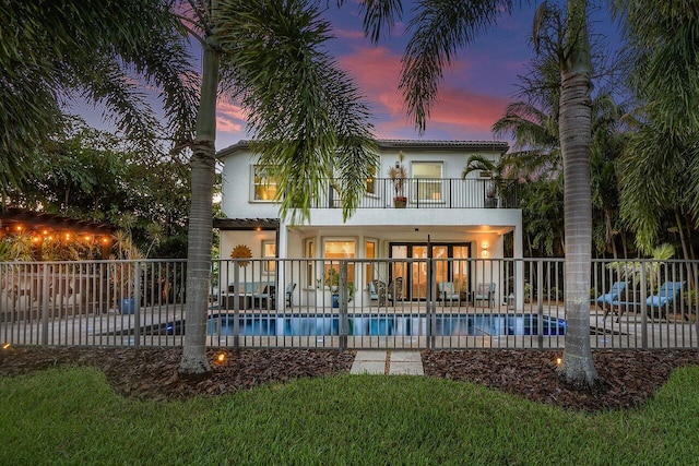 pool at dusk featuring a patio