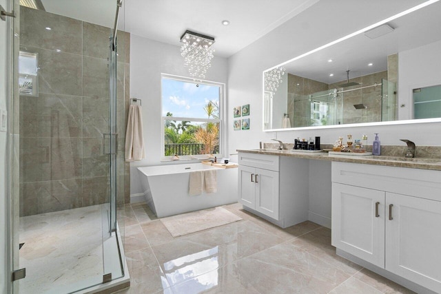 bathroom with a chandelier, vanity, and shower with separate bathtub