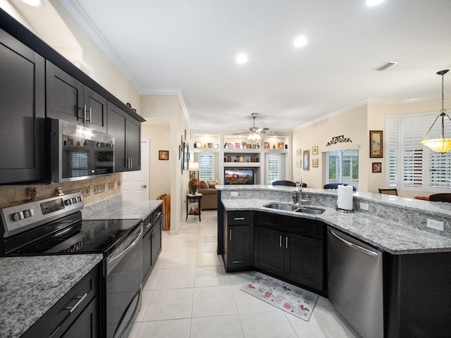 kitchen featuring light tile patterned flooring, tasteful backsplash, hanging light fixtures, sink, and appliances with stainless steel finishes