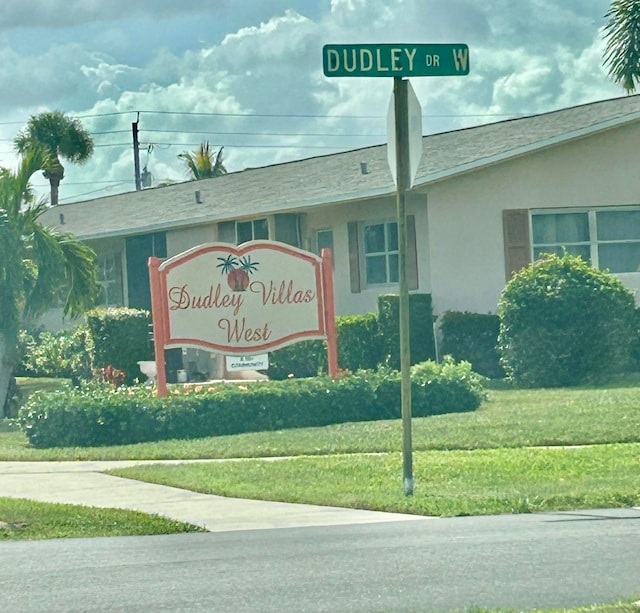 community / neighborhood sign with a lawn