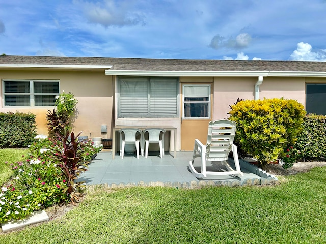 rear view of property with a patio and a yard