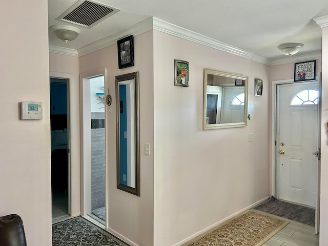 tiled foyer with ornamental molding