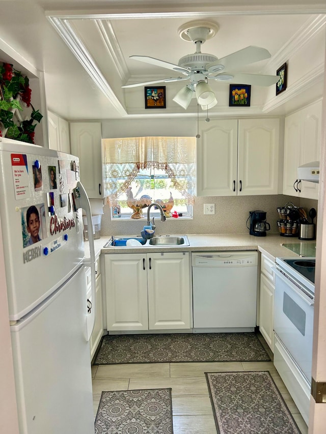 kitchen featuring white appliances, sink, crown molding, white cabinetry, and ceiling fan