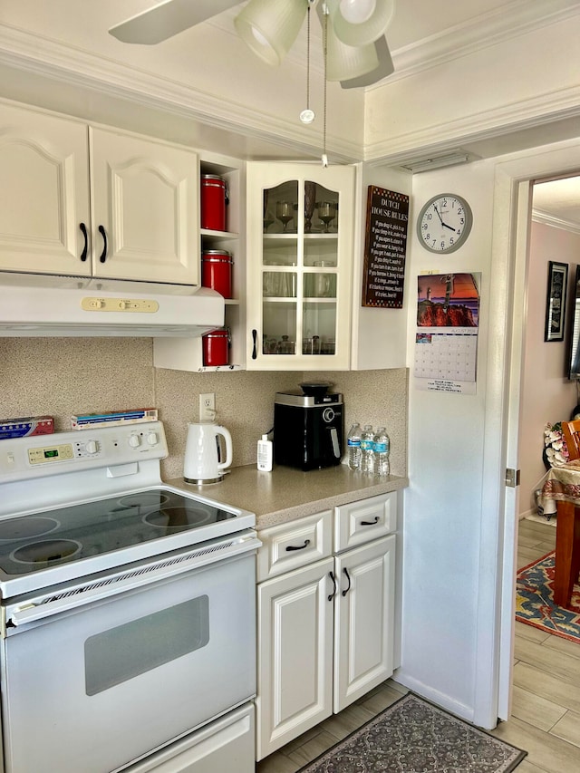 kitchen featuring white cabinetry, white range with electric stovetop, custom exhaust hood, and ceiling fan