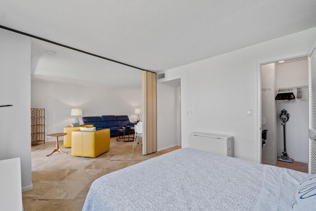 bedroom featuring a spacious closet and visible vents