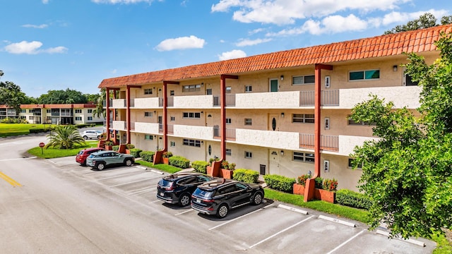 view of property featuring uncovered parking