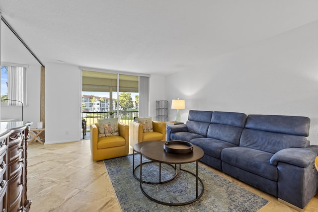 living area featuring baseboards and floor to ceiling windows