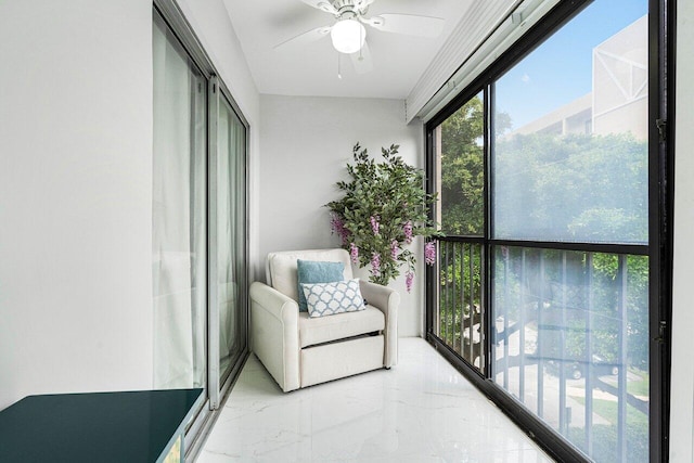 sunroom featuring ceiling fan